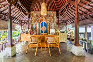 乌布Meruhdani Boutique Hotel Ubud的一间带桌椅的用餐室