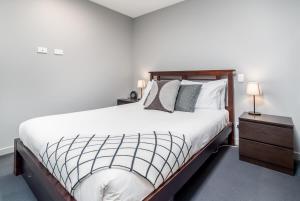 金斯顿Stunning 1BR Apartment with Water Views的卧室配有一张带白色床单和枕头的大床。