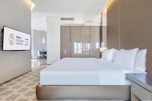 迪拜Spacious Studio Apartment in Hyatt Regency Dubai Creek Heights by the S Holiday Homes的一张大白色的床,位于酒店客房内