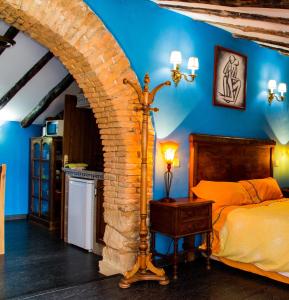 PlasenzuelaCASA GIBRANZOS的一间卧室设有一张床和砖墙