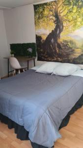 科皮亚波valle的一间卧室配有一张壁画床