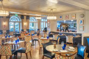 基督城Harbour Hotel & Spa Christchurch的一间带桌椅的餐厅和一间酒吧
