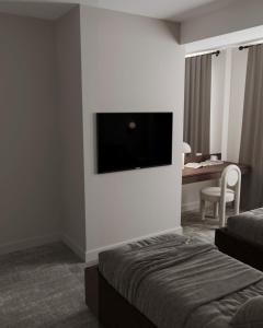 巴库Dastan Hotel Baku的酒店客房的墙上配有平面电视
