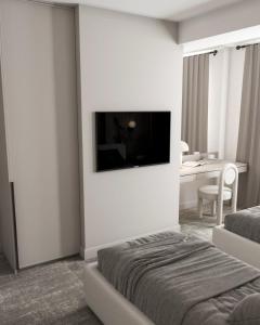 巴库Dastan Hotel Baku的酒店客房,设有床铺和墙上的电视