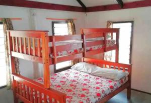 Nanuya LailaiGold Coast Inn - Adults Only的带2扇窗户的客房内的红色双层床
