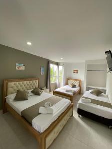 圣维罗尼卡HOTEL ARRECIFE的一间卧室设有两张床和大窗户