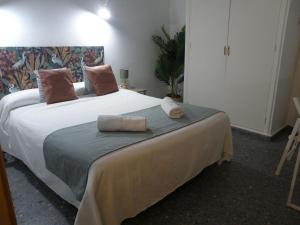 马贝拉Hostal Paco Marbella的一间卧室配有一张大床和两个枕头