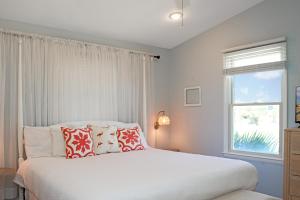 印第安帕斯WindScape by Pristine Properties Vacation Rentals的卧室配有带枕头的白色床和窗户。