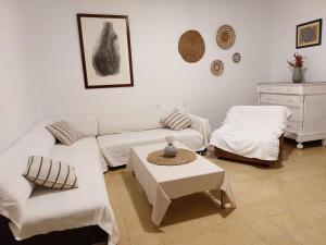 莱斯卡拉L'Escala - Pintor Massanet的客厅配有白色的沙发和桌子