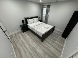 帕特森The Elegant Suite - 2BR with Great Amenities的一间卧室配有带白色床单和枕头的床。