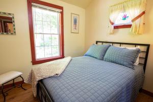 HamiltonLake Moraine Home #3 Near Colgate University的一间卧室设有蓝色的床和窗户。