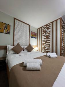 比什凯克Kausar Hotel的一间卧室配有一张大床和两个枕头