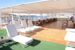 阿斯旺Nile Cruise Luxor Aswan 3,4 and 7 nights的船上的甲板,配有白色的椅子和桌子