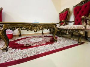 乌姆盖万Serene Nest的一间房间,配有两把椅子和红色地毯