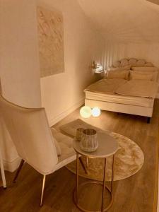 舍讷费尔德AMALFI HOME - Stylish apartment with terrace的一间卧室配有一张床、一把椅子和一张桌子