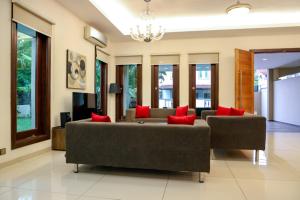 瓜埠Kuah Town - Villa Indah的带沙发和红色枕头的客厅