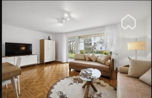 莱茵费尔登Apartment "Wirtschaftswunder"的带沙发和电视的客厅