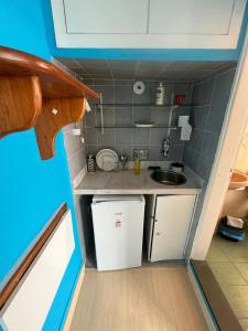 卡尚布Suíte Hotel São José的娃娃屋中带水槽的小厨房