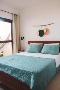伊卡莱Pousada Casa de Hóspedes的一间卧室配有一张带蓝色棉被的床和窗户。