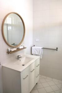 沃拉鲁垂钓者汽车旅馆的白色的浴室设有水槽和镜子