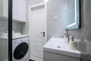 阿拉木图Апартаменты на Гагарина的白色的厨房配有洗衣机和水槽