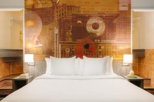 埃因霍温Crown Hotel Eindhoven Centre的卧室配有一张白色大床和壁画