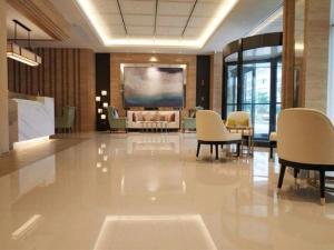 林后Jinjiang Inn Select Xiamen International Airport的大堂设有椅子和大屏幕
