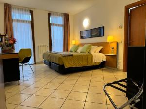 索马伦巴多Residence Malpensa的酒店客房,配有一张床、一张桌子和椅子