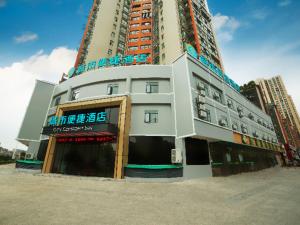 黄石City Comfort Inn Ezhou Huahu Airport High-speed Railway Station的前面有一间商店的高楼