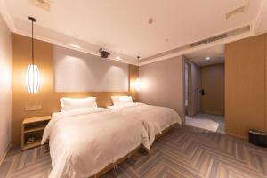 Hanting Premium Hotel Wenzhou Longwan Haicheng客房内的一张或多张床位