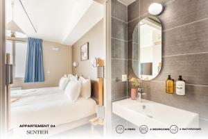 巴黎Beauquartier - Sentier的浴室设有床、水槽和镜子