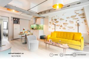 巴黎Beauquartier - Sentier的一间带黄色沙发的客厅和一间厨房