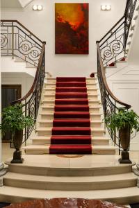 罗马InterContinental Rome Ambasciatori Palace, an IHG Hotel的楼梯上有一个红色地毯的楼梯