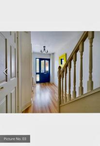 沃特福德3 bed terraced house.的走廊上,房子里有一个蓝色的门