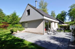 NoordwoldeVakantiepark Bosmeer Friesland的一座小砖房子,庭院里设有庭院