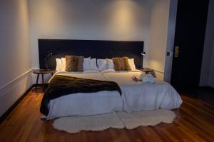 纳瓦塞拉达Hotel Arcipreste de Hita - Adults Only的卧室配有一张带白色床单和枕头的大床。