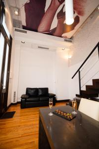 布宜诺斯艾利斯Loft Osteria by Sagardi的客厅配有沙发和两杯葡萄酒