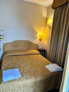 威尼斯Hotel Ristorante Ca' Nova的一间卧室配有一张床,上面有两条毛巾