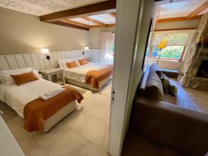 圣卡洛斯-德巴里洛切拉斯维加斯马里亚纳宾馆的一间卧室配有两张床和一张沙发。