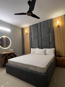 卡拉奇Marigold Accommodations的一间卧室配有一张带吊扇的床