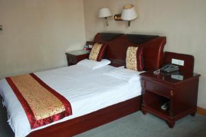台州台山商务宾馆的一间卧室配有一张床,床头柜配有电话