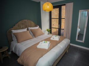 Werkendam't Huske的一间卧室配有一张大床和毛巾