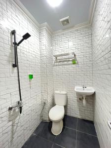 SentoolAyuri Hotel Malioboro的白色的浴室设有卫生间和水槽。