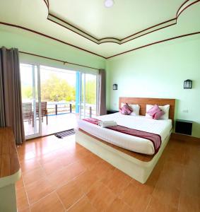涛岛海景度假木屋的一间带大床的卧室和一个阳台