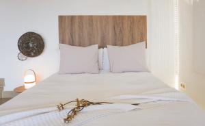 卡斯特罗·德波利亚斯Costa Brava acollidor apartament amb gran terrassa per a 3 persones的一张带白色床单和白色枕头的床