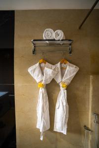 DhanwārCitrus Prime Kanha Resort and Villas的两件白色衬衫挂在墙上