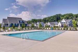 柏斯海滩Luxe Rehoboth Beach House with Community Pool and Gym!的一个带椅子和房屋的度假村的游泳池