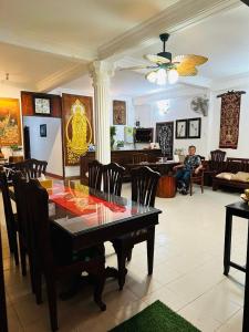 琅勃拉邦Mano boutique sun shine的一间带桌椅和男人的用餐室