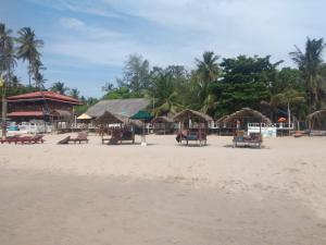 亭可马里Udayam guest的沙滩上带椅子和遮阳伞的海滩