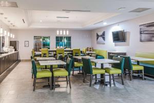 汤博尔汤博尔拉昆塔酒店及套房的用餐室配有桌子和黄色椅子